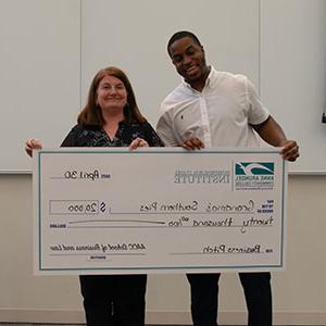 Grandma's Southern Pies pitcher holding a large check with Stephanie Goldenberg